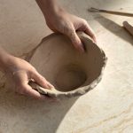 Caesarstone ICON 8251 Taj Whisper surface with hands creating a Clay bowl